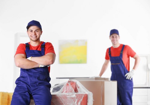 Trained movers using safety equipment in a removal van operation