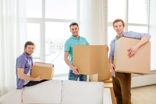 Movers carefully carrying bulky furniture through a Paddington property