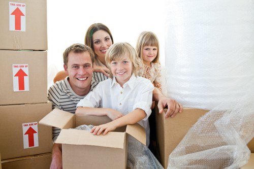Packed boxes being loaded into a Paddington removal van